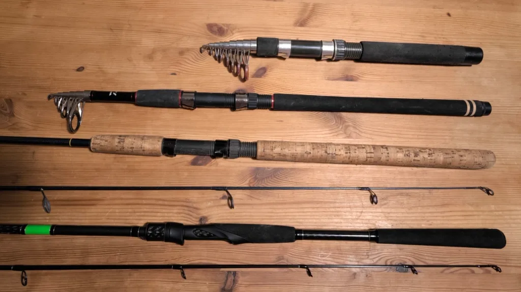 4 spinning rods on a wooden table.