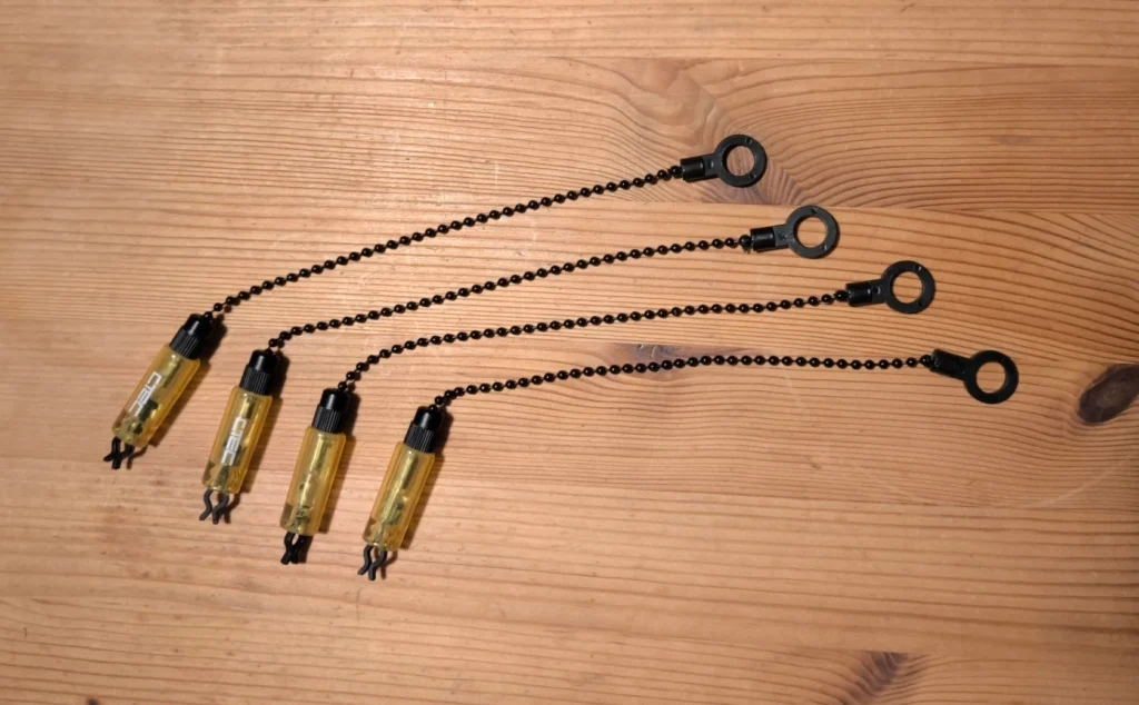 4 bobbins on a wooden table.